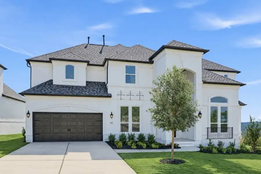 Front exterior of a new home in Travisso, Leander, TX, highlighting curb appeal (Image 2). Front exterior of a new home in Travisso, Leander, TX, highlighting curb appeal (Image 2).