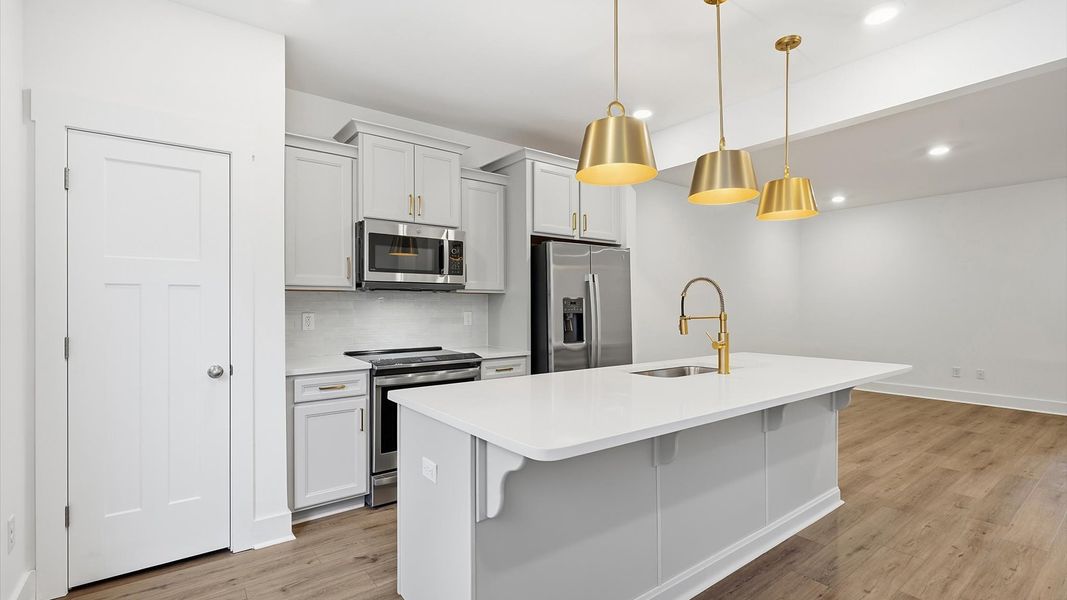 Exceptional culinary space with a striking center island and eye-catching pendant lights at Clayton Crossing