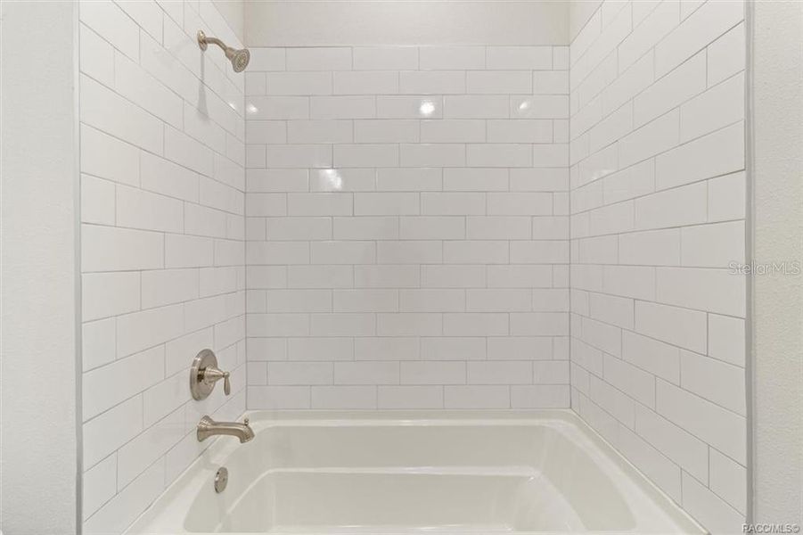 2nd bathroom includes tiled tub surround