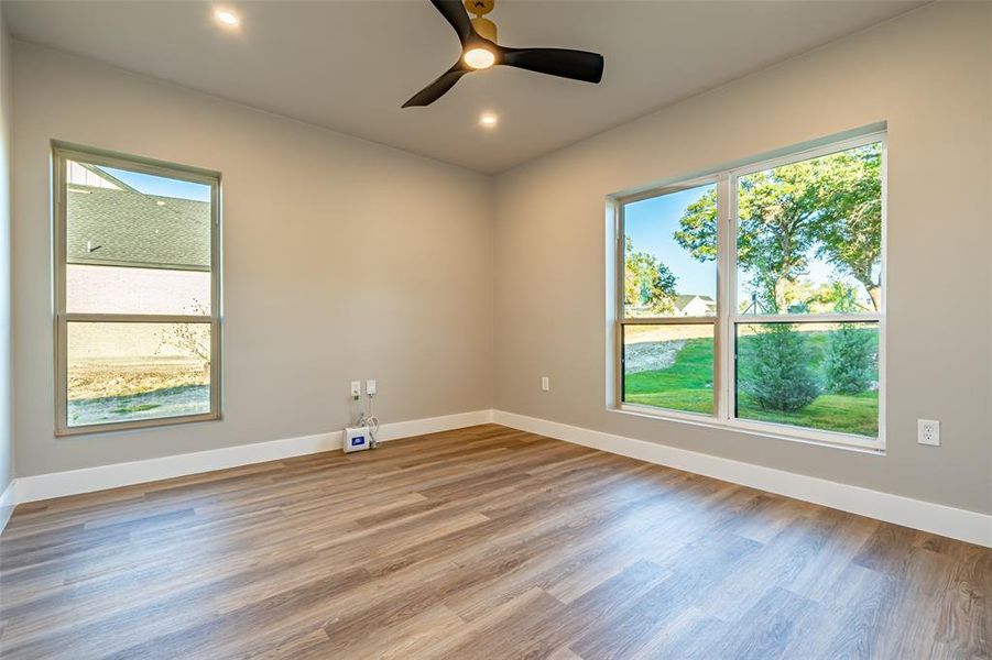 Unfurnished room with light wood-type flooring, recessed lighting, and a ceiling fan Unfurnished room with light wood-type flooring, recessed lighting, and a ceiling fan