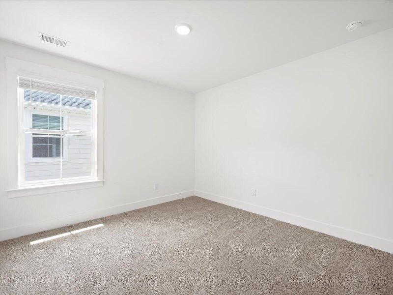Spacious, unfurnished interior of a new home in The Coves at Lakes of Cane Bay, Summerville (Image 36).