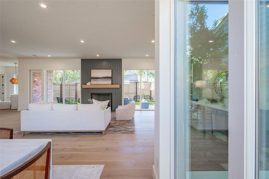 Living room with light wood-type flooring and a fireplace