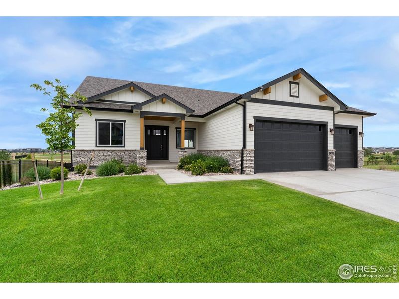 Front exterior of a new home in Aurora Highlands, Aurora, CO, highlighting curb appeal (Image 2). Front exterior of a new home in Aurora Highlands, Aurora, CO, highlighting curb appeal (Image 2).