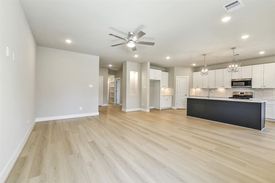 Expansive open floor plan with clean lines and neutral finishes offering flexibility for living and entertaining.