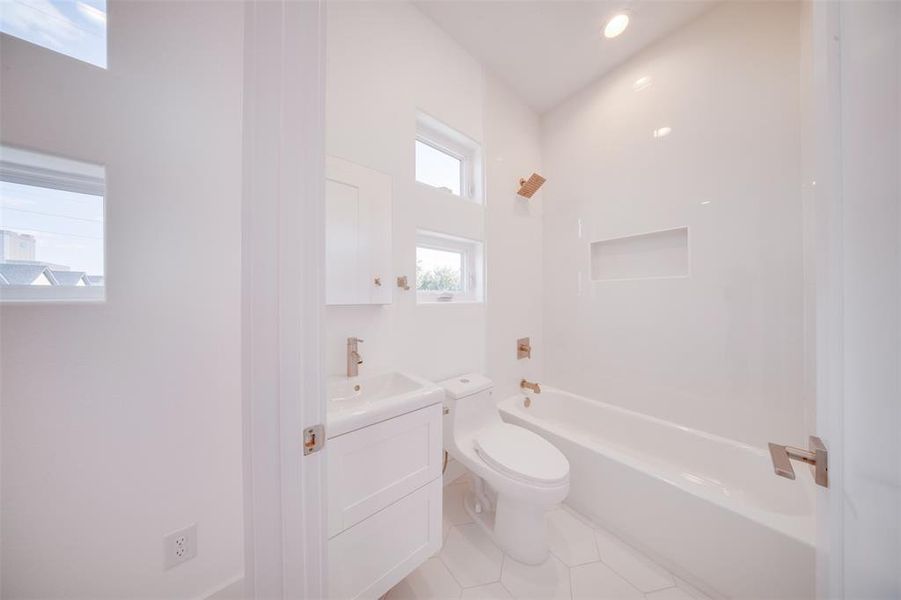 Full bathroom featuring vanity, tile patterned flooring, toilet, and tub / shower combination