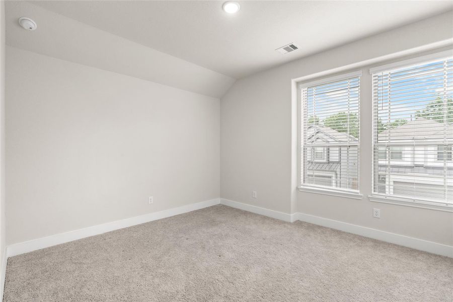 Designed to adapt alongside changing needs, this secondary bedroom offers the flexibility to function as a guest room, nursery, home office, or creative space.