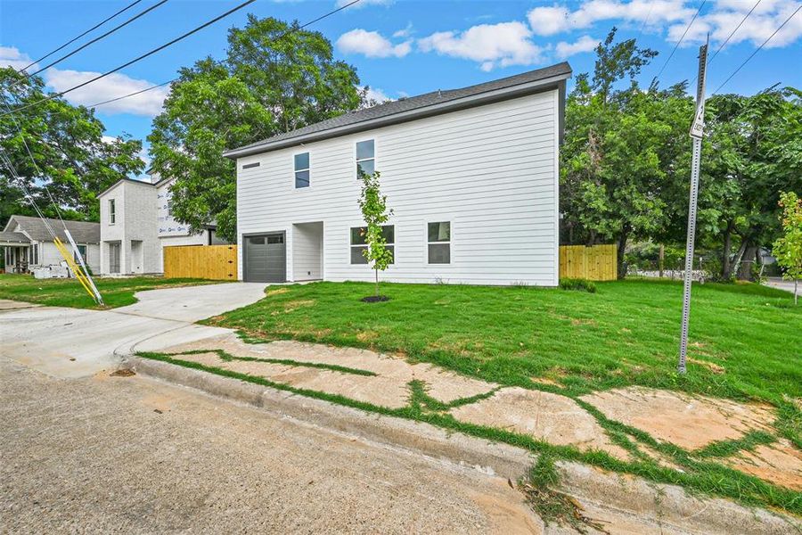 View of front facade with a garage and a front lawn