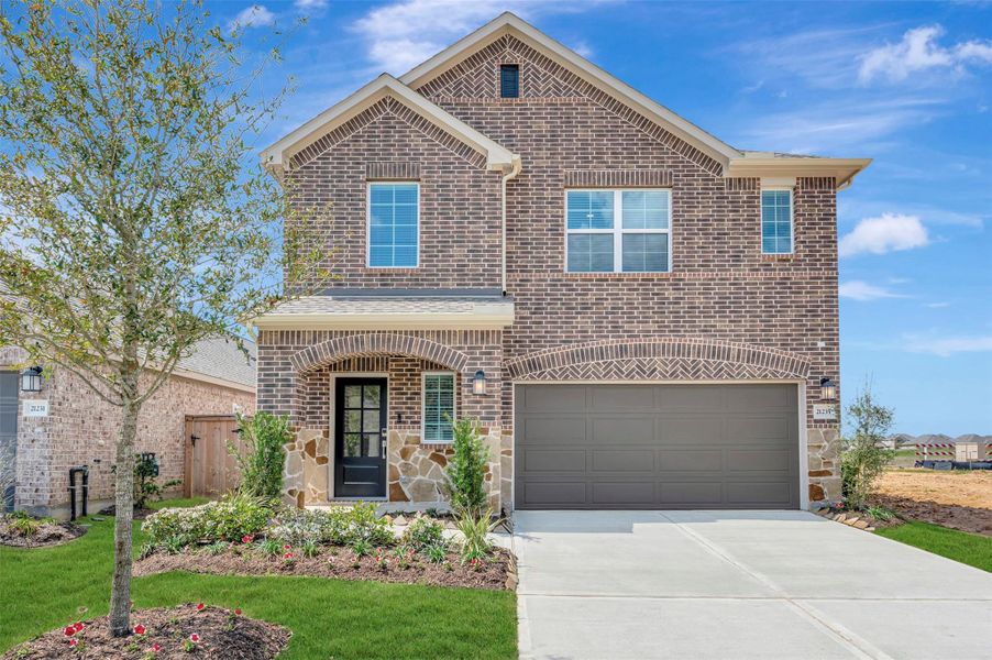 Front exterior of a new home in Sorella, Tomball, TX, highlighting curb appeal (Image 18).