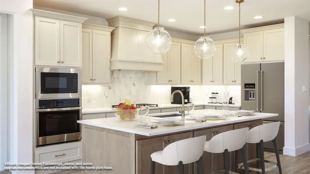 Kitchen with backsplash, stainless steel appliances, custom exhaust hood, wood finished floors, and an island with sink Kitchen with backsplash, stainless steel appliances, custom exhaust hood, wood finished floors, and an island with sink