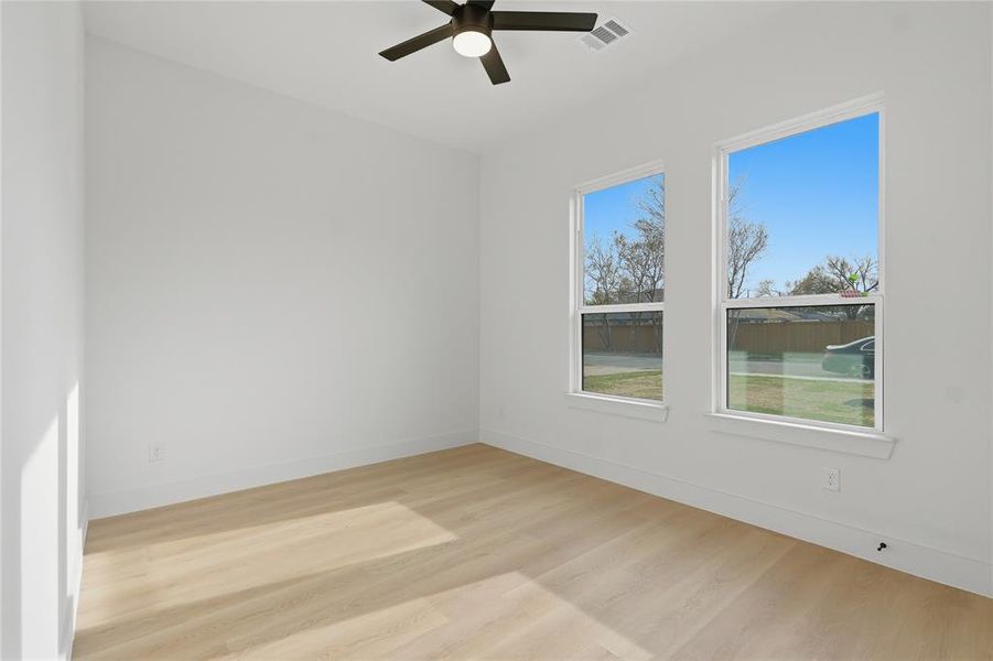 Spare room featuring light wood finished floors and ceiling fan Spare room featuring light wood finished floors and ceiling fan