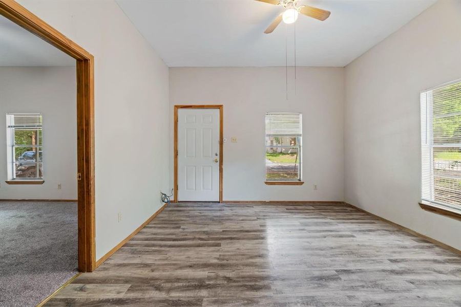 Unfurnished room with a ceiling fan and light wood-style flooring Unfurnished room with a ceiling fan and light wood-style flooring