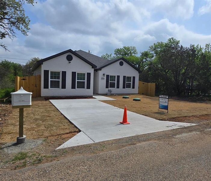 Ranch-style house with stucco siding and fence Ranch-style house with stucco siding and fence