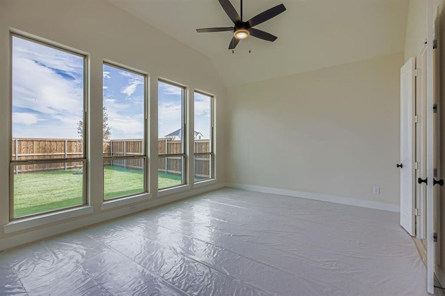 Empty room with vaulted ceiling and ceiling fan Empty room with vaulted ceiling and ceiling fan