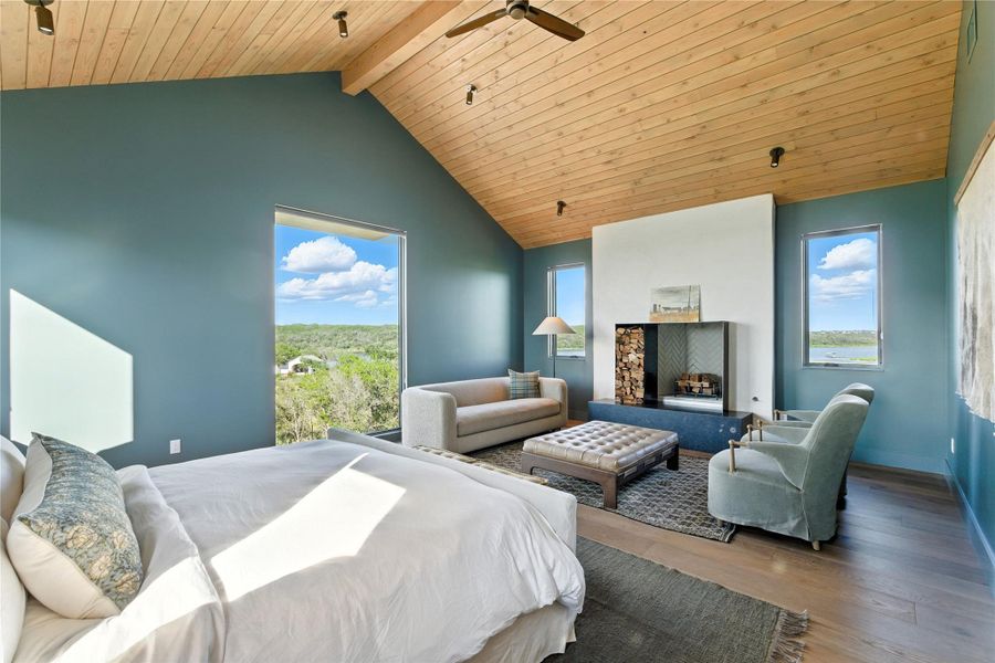 Bedroom featuring multiple windows, hardwood / wood-style floors, a wooden ceiling with exposed beams, ceiling fan, and high vaulted ceiling