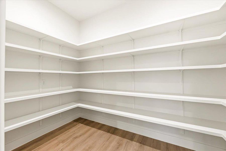 Ample built-in shelving provides generous storage space in this well-appointed pantry.