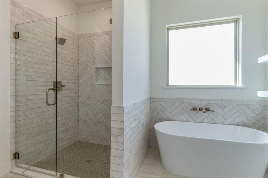 Bathroom with separate shower and tub, tile walls, and tile patterned floors