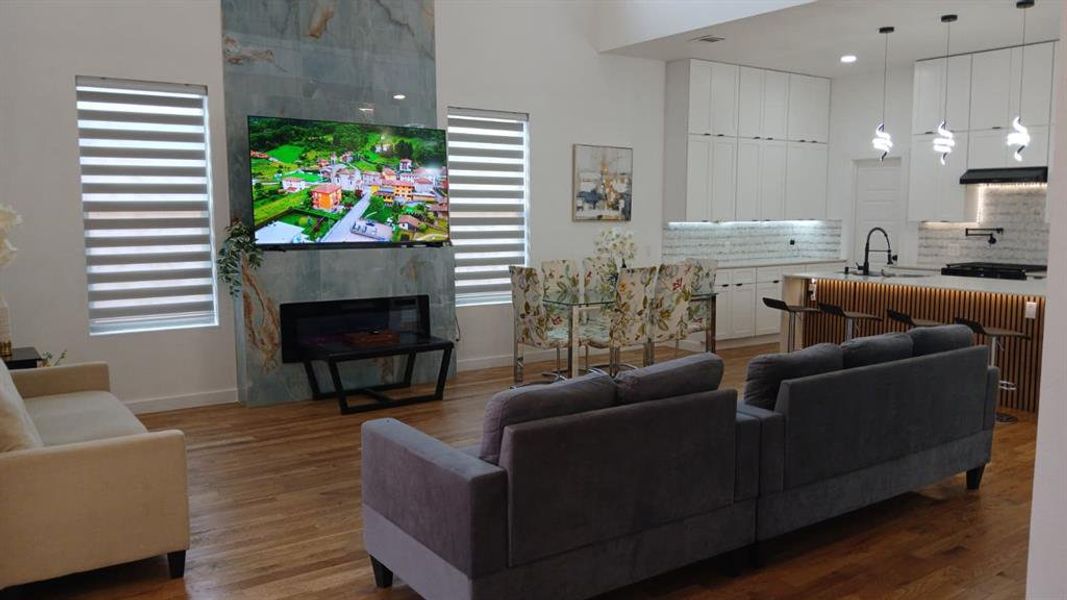 Open-concept living space featuring wood-finish flooring throughout