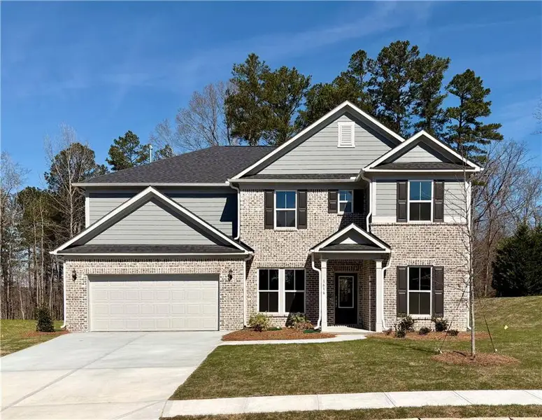 Front exterior of a new home in Riversprings, Dacula, GA, highlighting curb appeal (Image 1). Front exterior of a new home in Riversprings, Dacula, GA, highlighting curb appeal (Image 1).