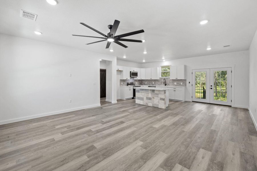 A streamlined kitchen layout blends seamlessly with an adjacent living space, featuring contemporary finishes and outdoor access. A streamlined kitchen layout blends seamlessly with an adjacent living space, featuring contemporary finishes and outdoor access.