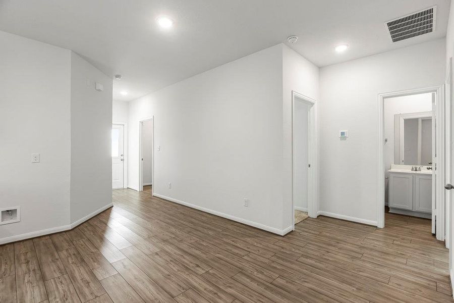Spare room with wood finished floors and recessed lighting