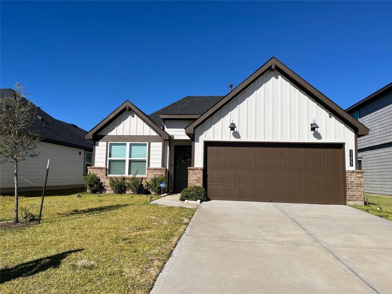Front exterior of a new home in Tamarron, Fulshear, TX, highlighting curb appeal (Image 1).