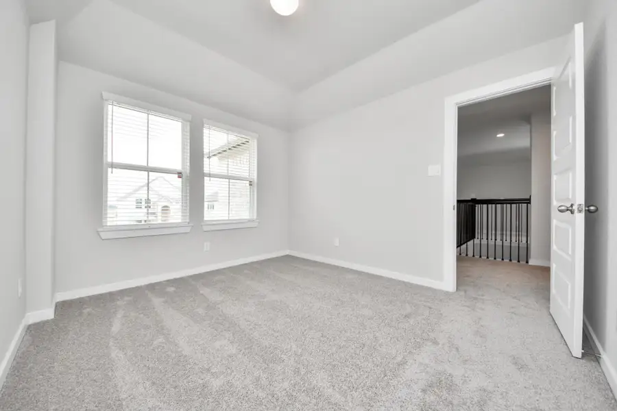 Generously sized secondary bedrooms featuring spacious closets, soft and inviting carpeting underfoot, large windows allowing plenty of natural light, and the added touch of privacy blinds for your personal retreat. Sample photo of completed home with similar floor plan. Actual colors and selections may vary.