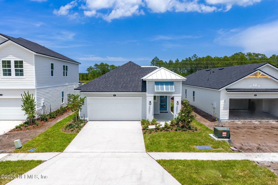 Front exterior of a new home in Beacon Lake, St. Augustine, FL, highlighting curb appeal (Image 37).