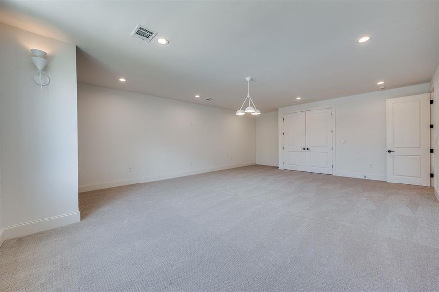 Below grade area featuring light carpet and recessed lighting