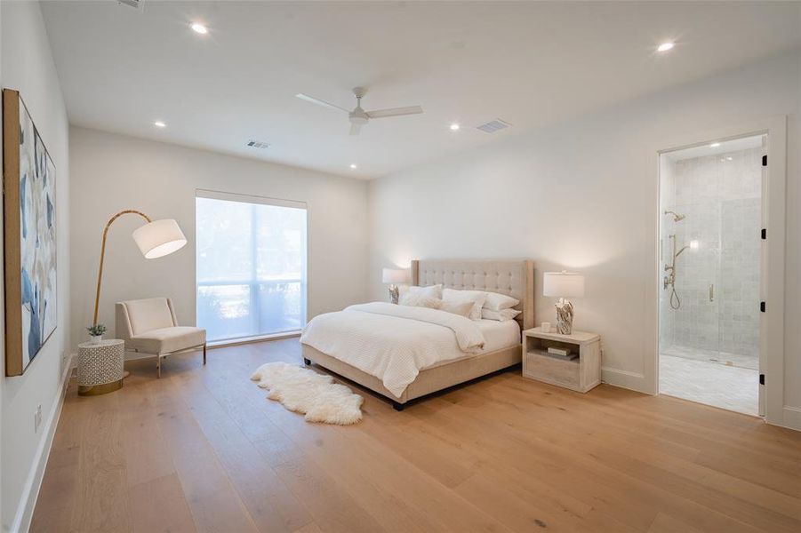 Bedroom featuring connected bathroom, light hardwood / wood-style floors, and ceiling fan