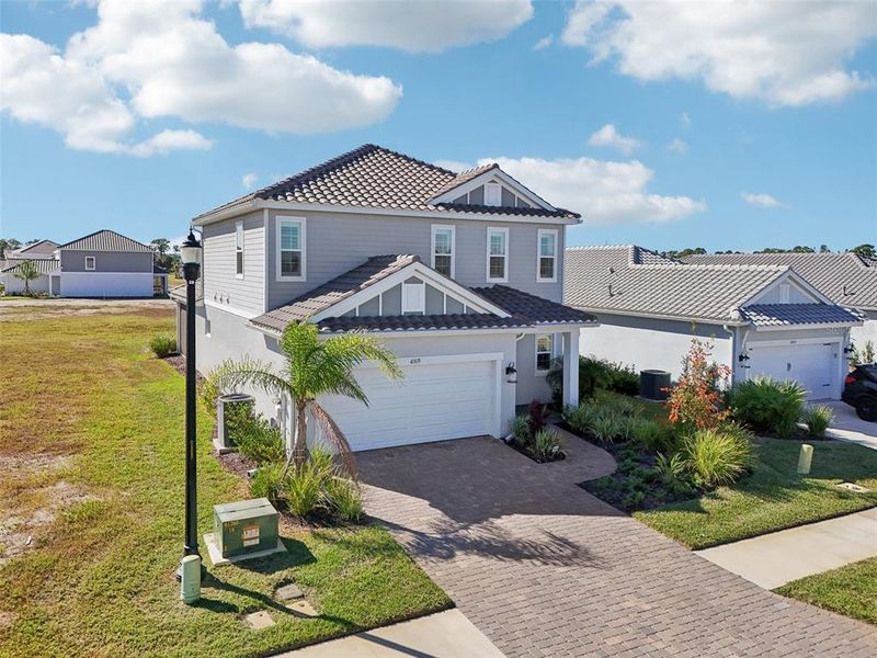 Front exterior of a new home in , Sarasota, FL, highlighting curb appeal (Image 27). Front exterior of a new home in , Sarasota, FL, highlighting curb appeal (Image 27).