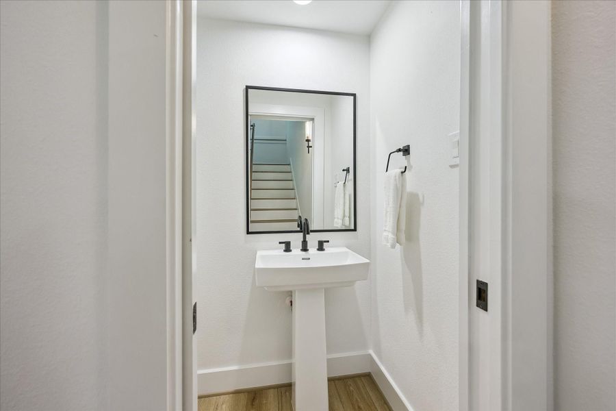 A conveniently located powder bath is tucked discreetly off the stair landing. A conveniently located powder bath is tucked discreetly off the stair landing.