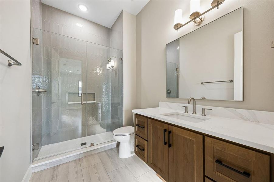 Bathroom featuring vanity and a shower stall Bathroom featuring vanity and a shower stall