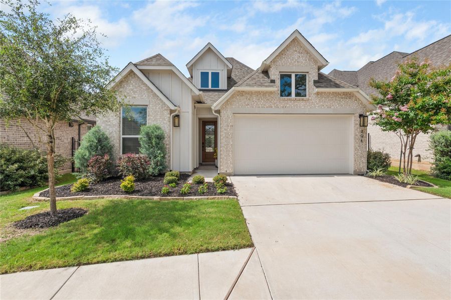 A charming single-family home with an attached garage and well-maintained front yard landscaping. A charming single-family home with an attached garage and well-maintained front yard landscaping.