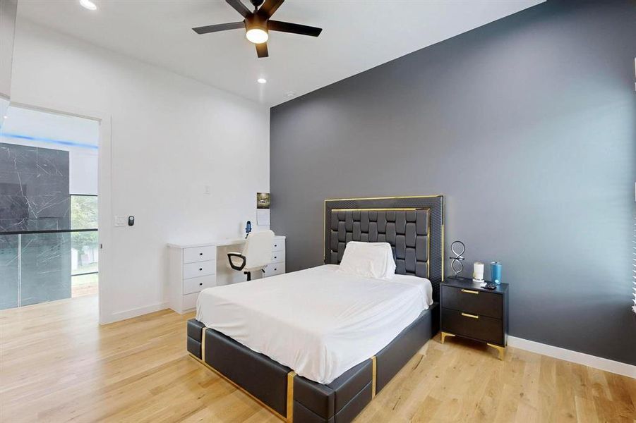 Bedroom with light wood-style floors, recessed lighting, and a ceiling fan Bedroom with light wood-style floors, recessed lighting, and a ceiling fan