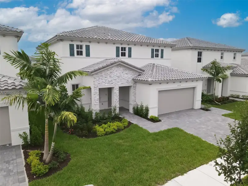 Front exterior of a new home in , Homestead, FL, highlighting curb appeal (Image 2). Front exterior of a new home in , Homestead, FL, highlighting curb appeal (Image 2).