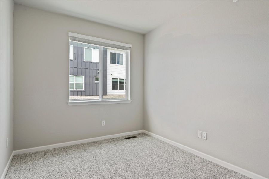 A room with a window and a carpet.