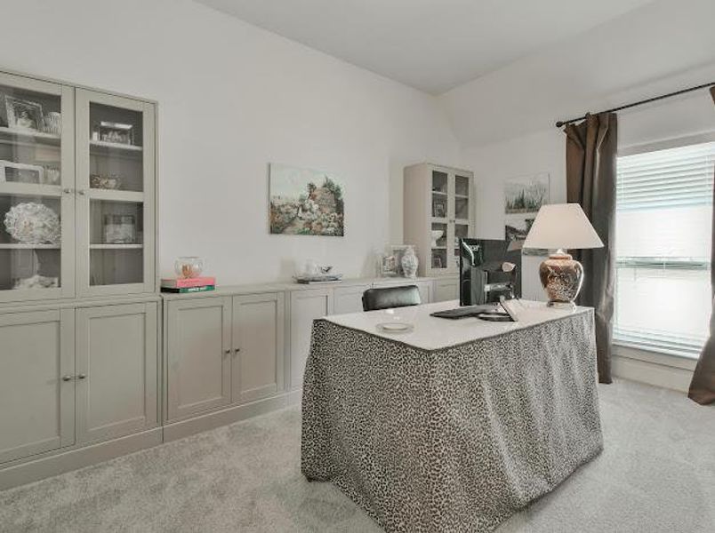 Office featuring light colored carpet and lofted ceiling Office featuring light colored carpet and lofted ceiling