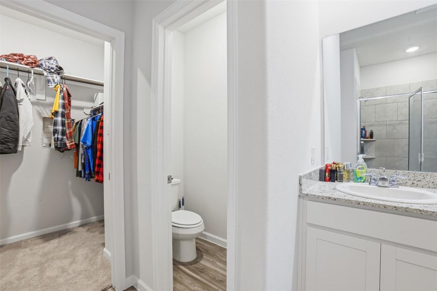 Primary bath with closet and storage closet