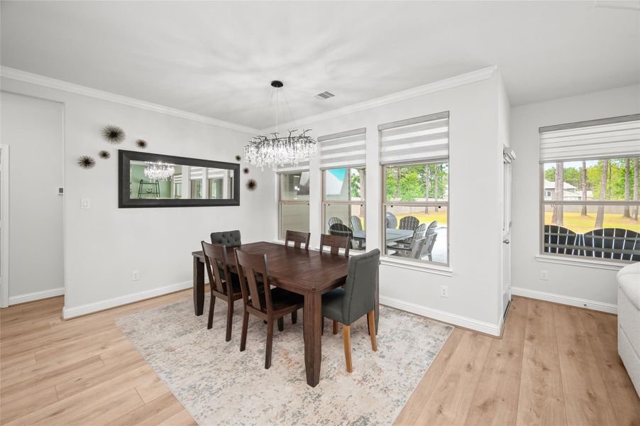 Breakfast room with a stunning chandelier and ample space for a large table for entertaining.
