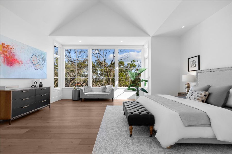 Bedroom featuring multiple windows, wood finished floors, vaulted ceiling, and recessed lighting Bedroom featuring multiple windows, wood finished floors, vaulted ceiling, and recessed lighting