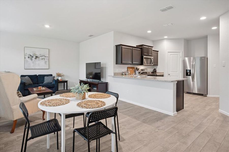 Dining space featuring recessed lighting and light wood finished floors Dining space featuring recessed lighting and light wood finished floors