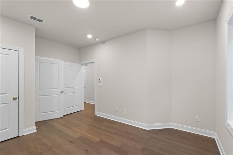 Unfurnished bedroom featuring dark wood finished floors and recessed lighting