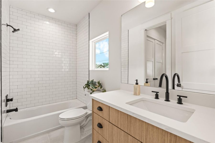 First-floor full bath — three full baths in this home, matte black hardware, tiled shower First-floor full bath — three full baths in this home, matte black hardware, tiled shower