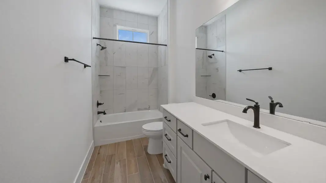 Representative furnished interior of a home built from the Waterloo by Chesmar Homes in Sofi Lakes, Katy (Image 12).
