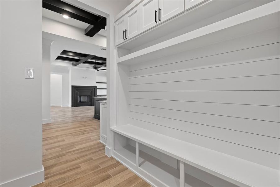 Mudroom with ceiling fan, coffered ceiling, beamed ceiling, and light hardwood / wood-style flooring