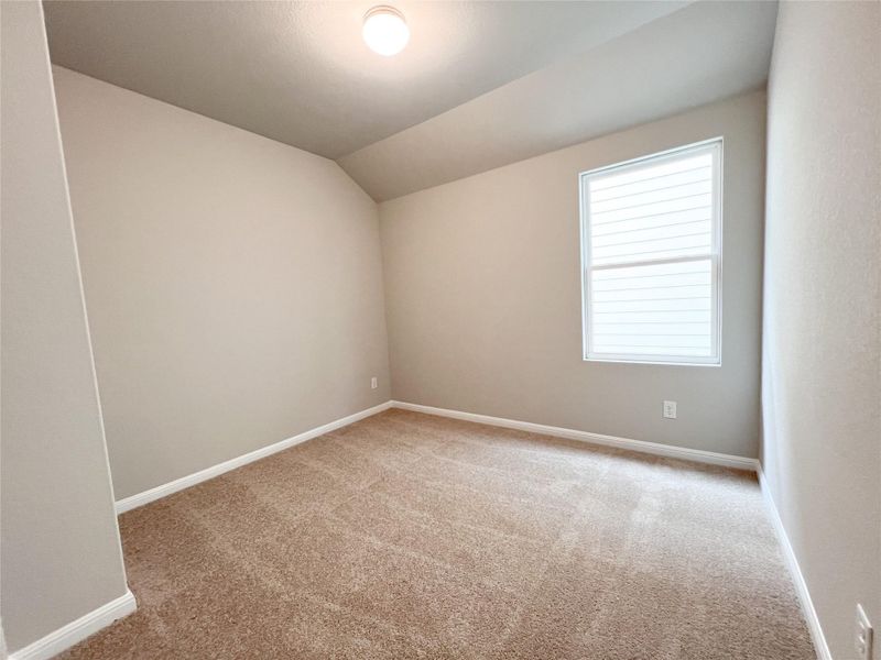 An inviting secondary bedroom offers soft carpet flooring and a sun-filled window, perfect for quiet retreat. An inviting secondary bedroom offers soft carpet flooring and a sun-filled window, perfect for quiet retreat.