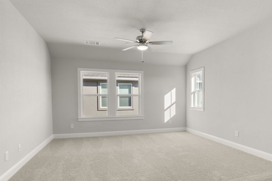 Image of a flex room with tan carpeting and light grey painted walls with two windows and a ceiling fan Image of a flex room with tan carpeting and light grey painted walls with two windows and a ceiling fan