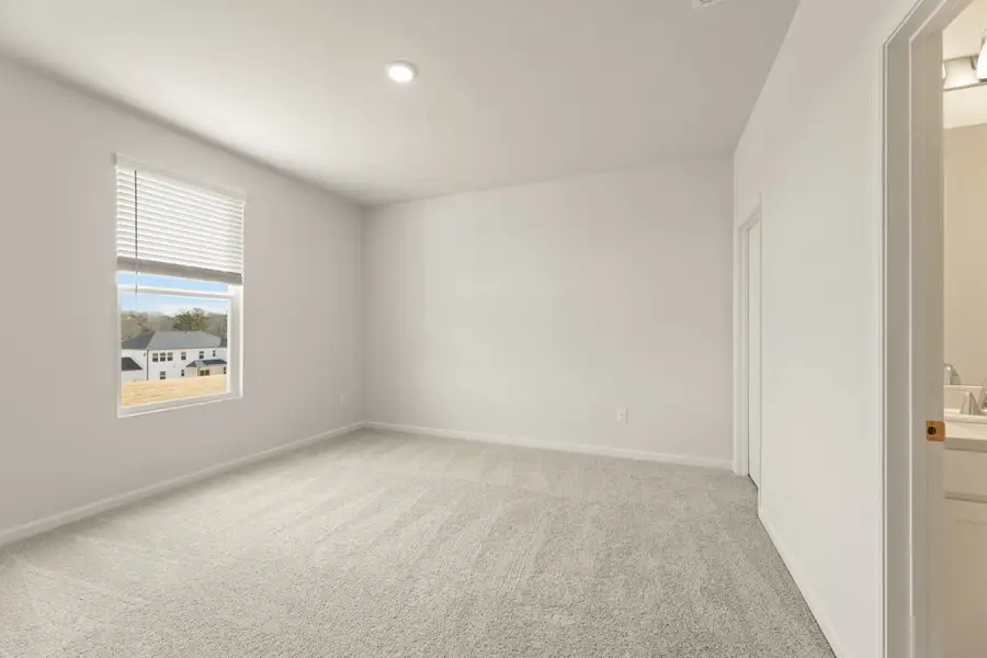 A room with a window and a carpet. A room with a window and a carpet.
