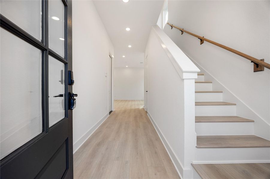 Walking into this gorgeous home, you get a feel of just how open and bright everything is. This space showcases soaring high ceilings, recessed lighting, custom paint for a cooling feel, and gorgeous wood flooring. This home is absolutely beautiful!