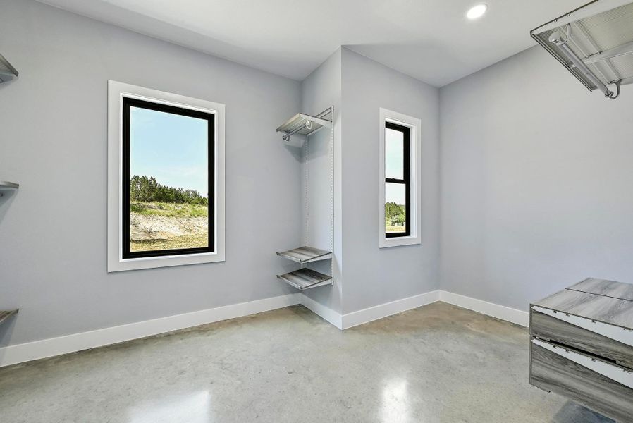 The oversized primary walk-in closet comes with a high-end organizational system. The oversized primary walk-in closet comes with a high-end organizational system.